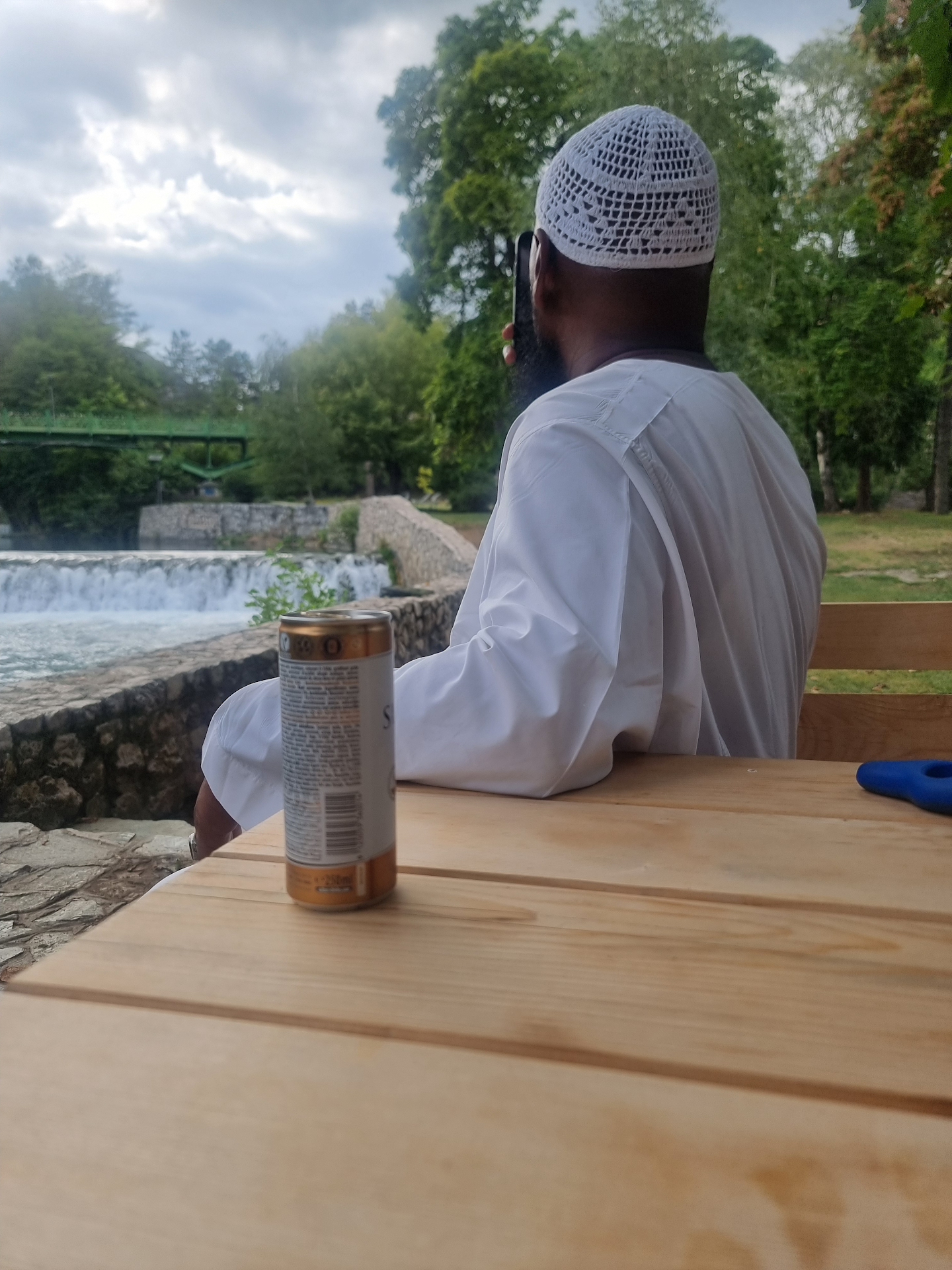 Peaceful riverside moment — A quiet pause beside Bosnia's clear, flowing water.